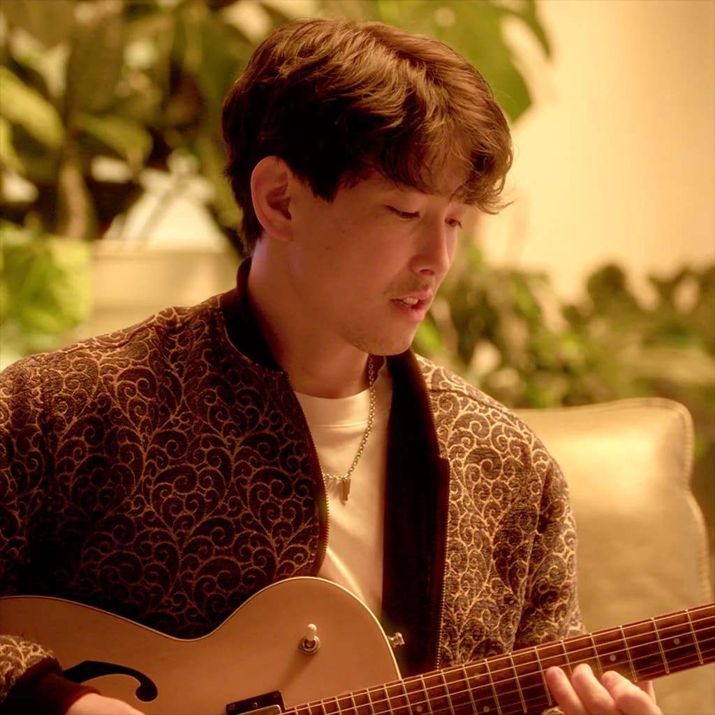 Sam Nakamura playing guitar